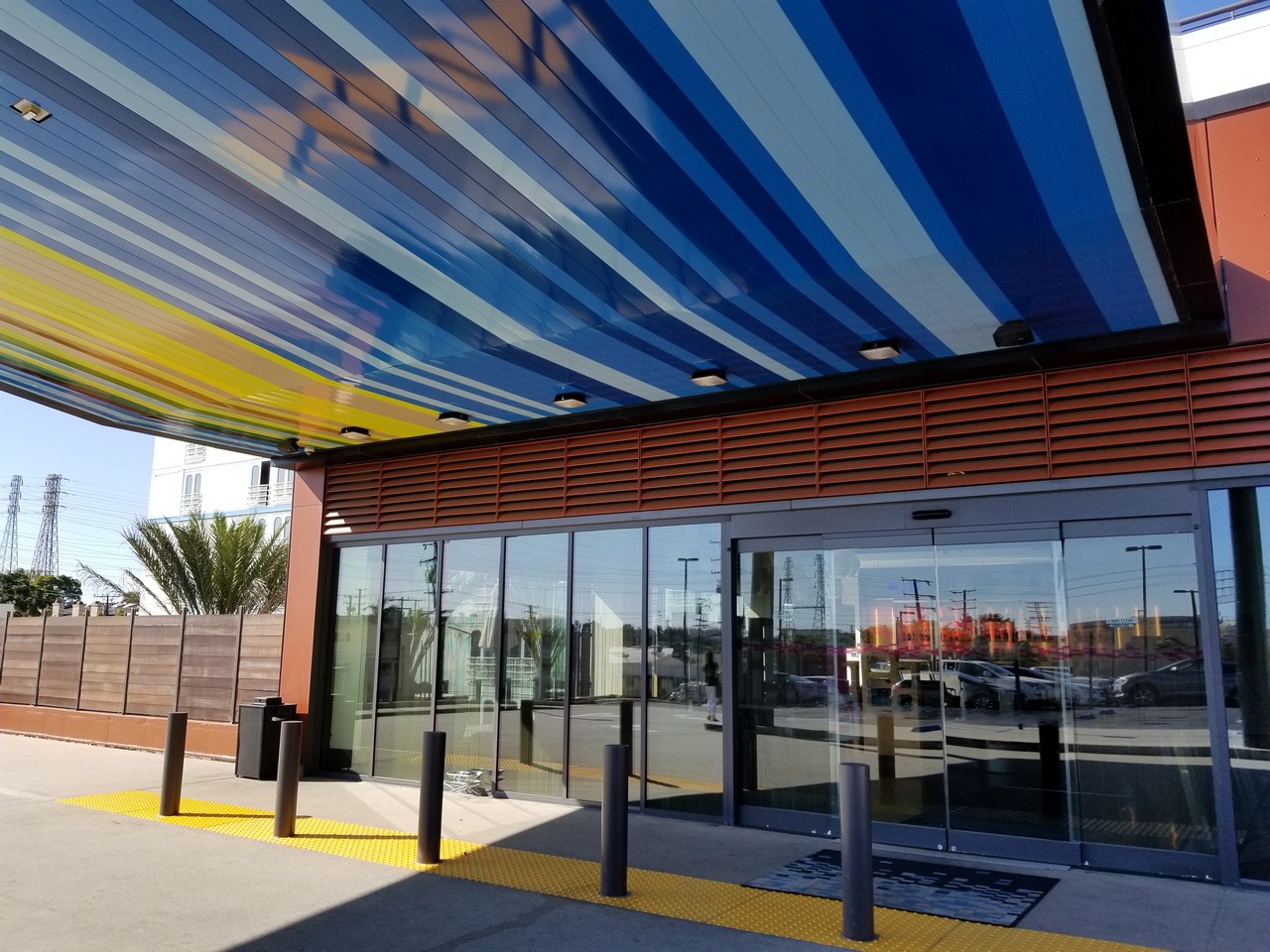 a building with glass doors and a blue and yellow striped ceiling