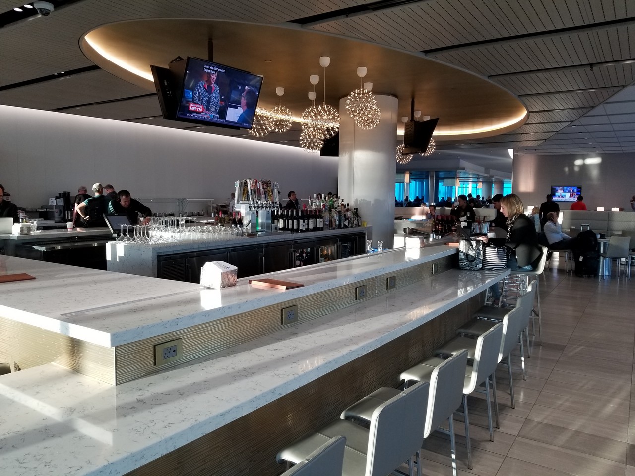 a bar with many people sitting at the counter