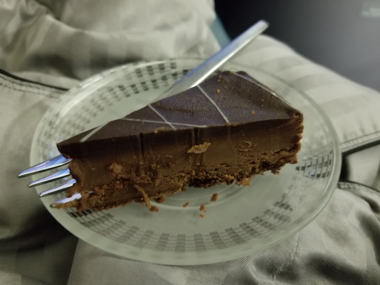 a piece of chocolate cake on a plate with a fork
