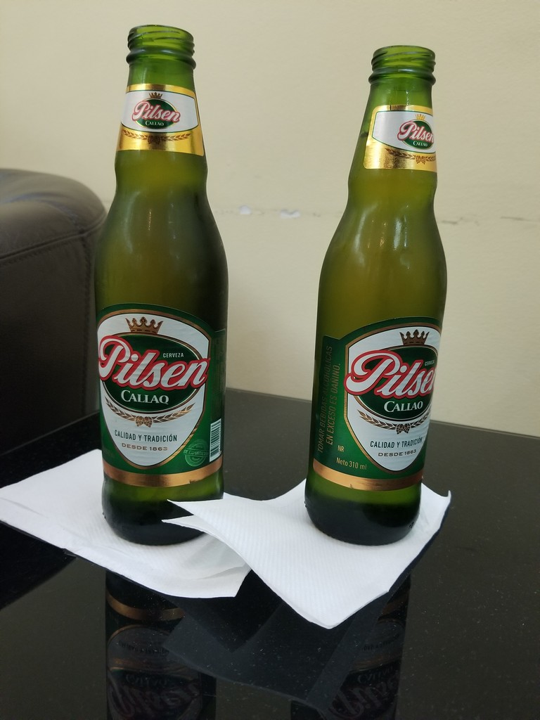 two green bottles on a table