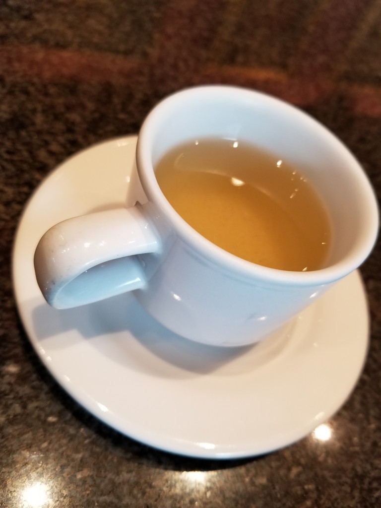 a cup of liquid on a saucer