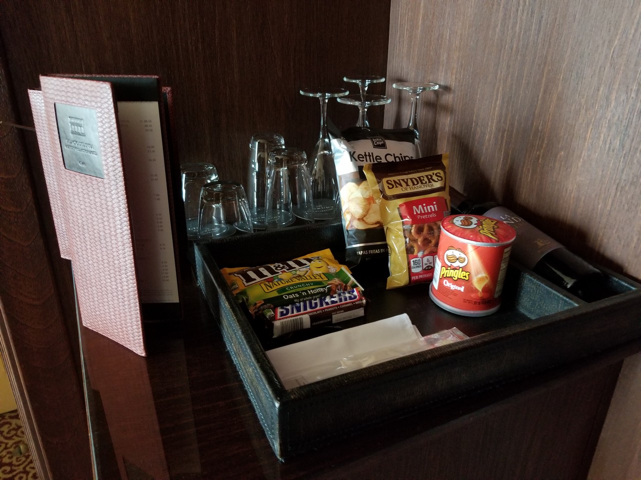 a tray with snacks and glasses on it