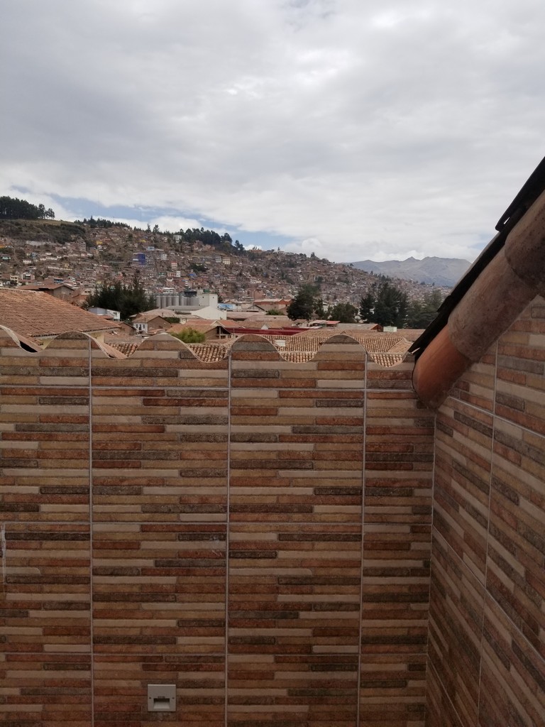 a brick wall with a city in the background
