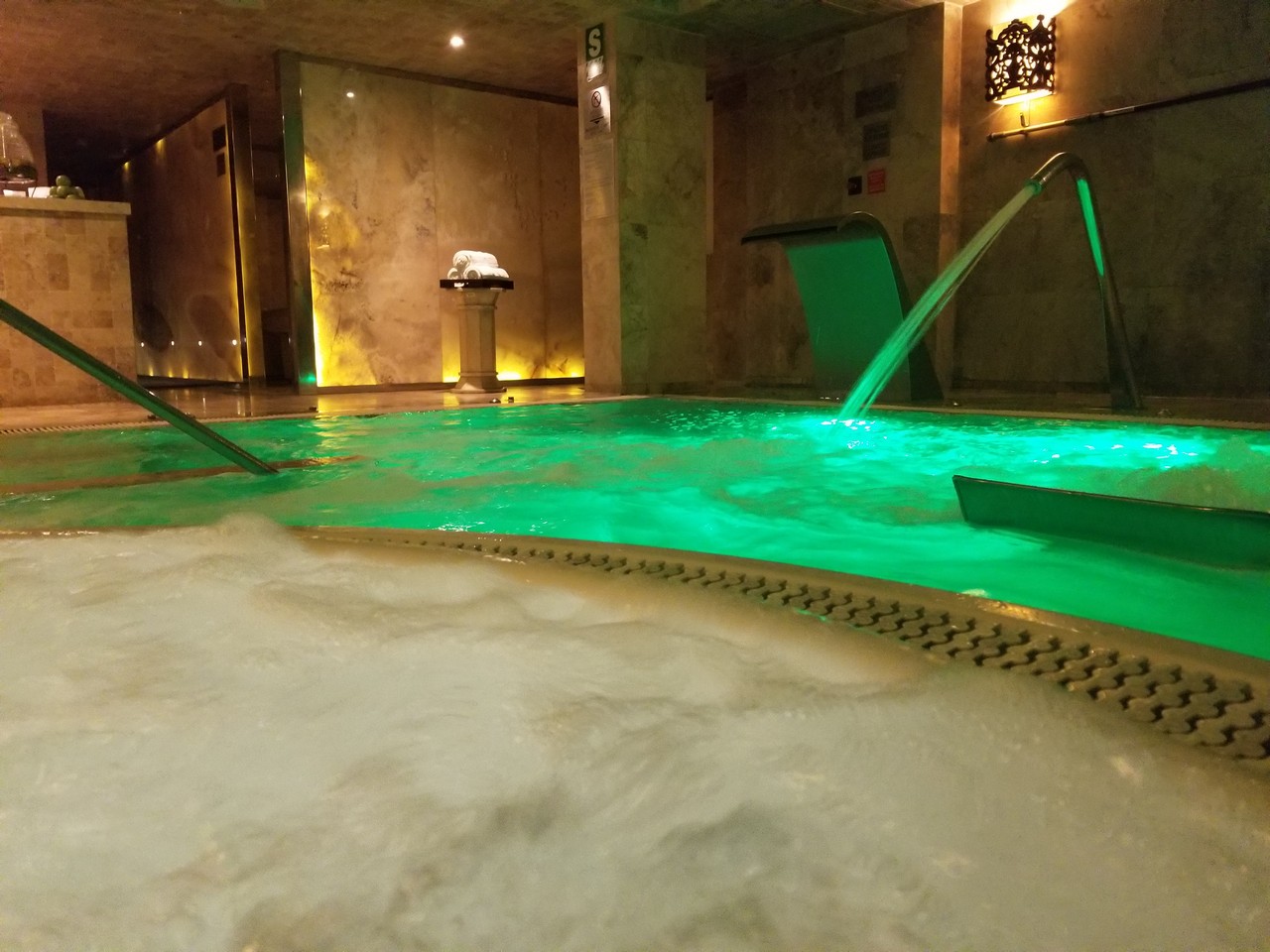 a large indoor jacuzzi with green lights