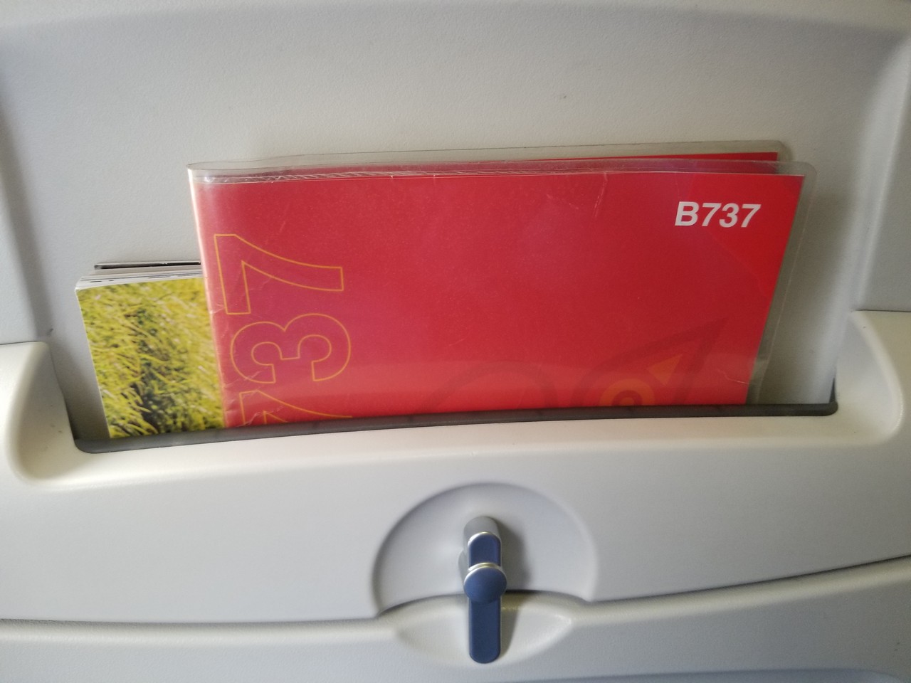 a red folder in a plastic holder