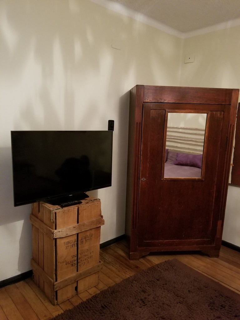 a tv on a box next to a cabinet