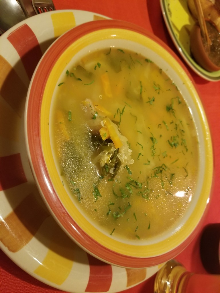 a bowl of soup with greens