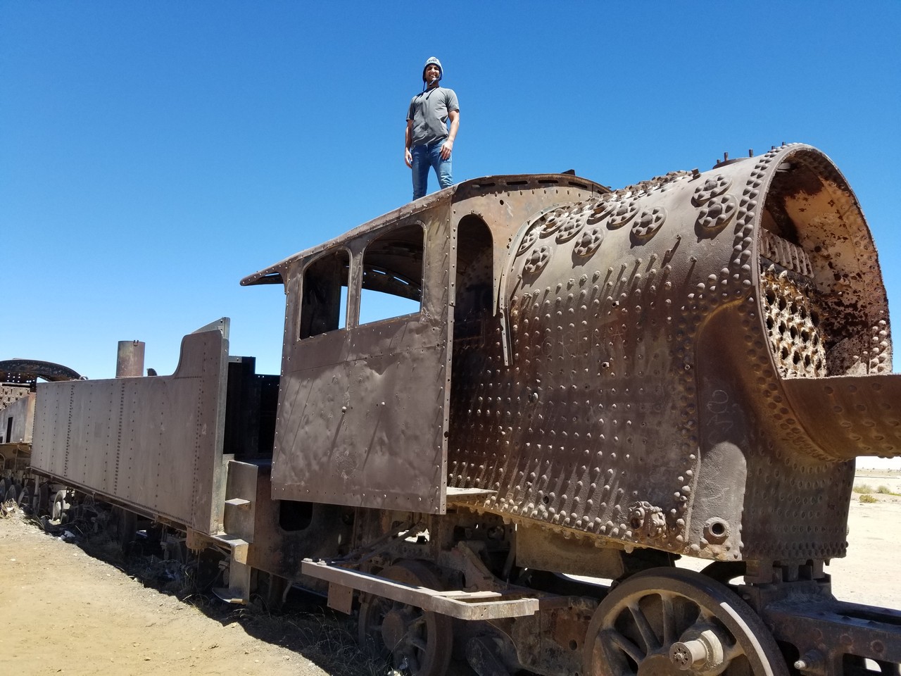 a man standing on top of a rusty train