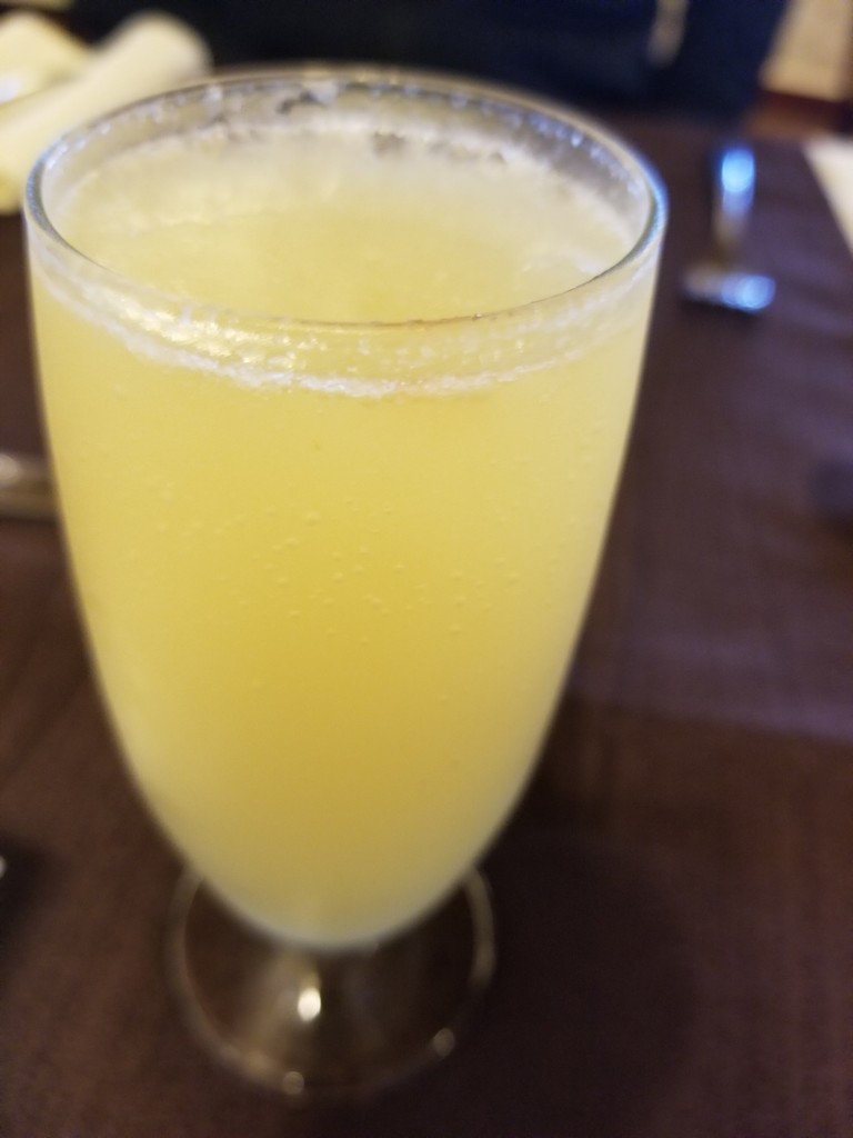 a glass of yellow liquid