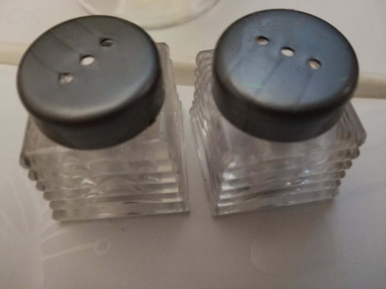 a couple of clear containers with black caps