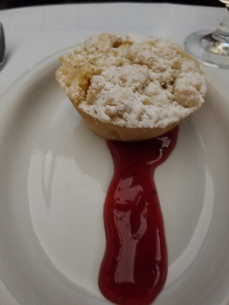 a small pastry with a sauce on a plate
