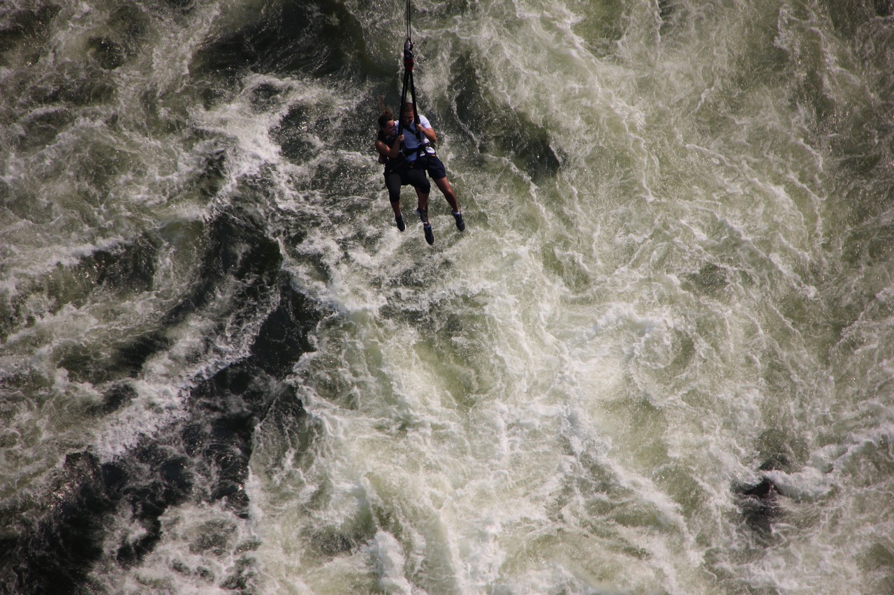 a person on a rope in a river