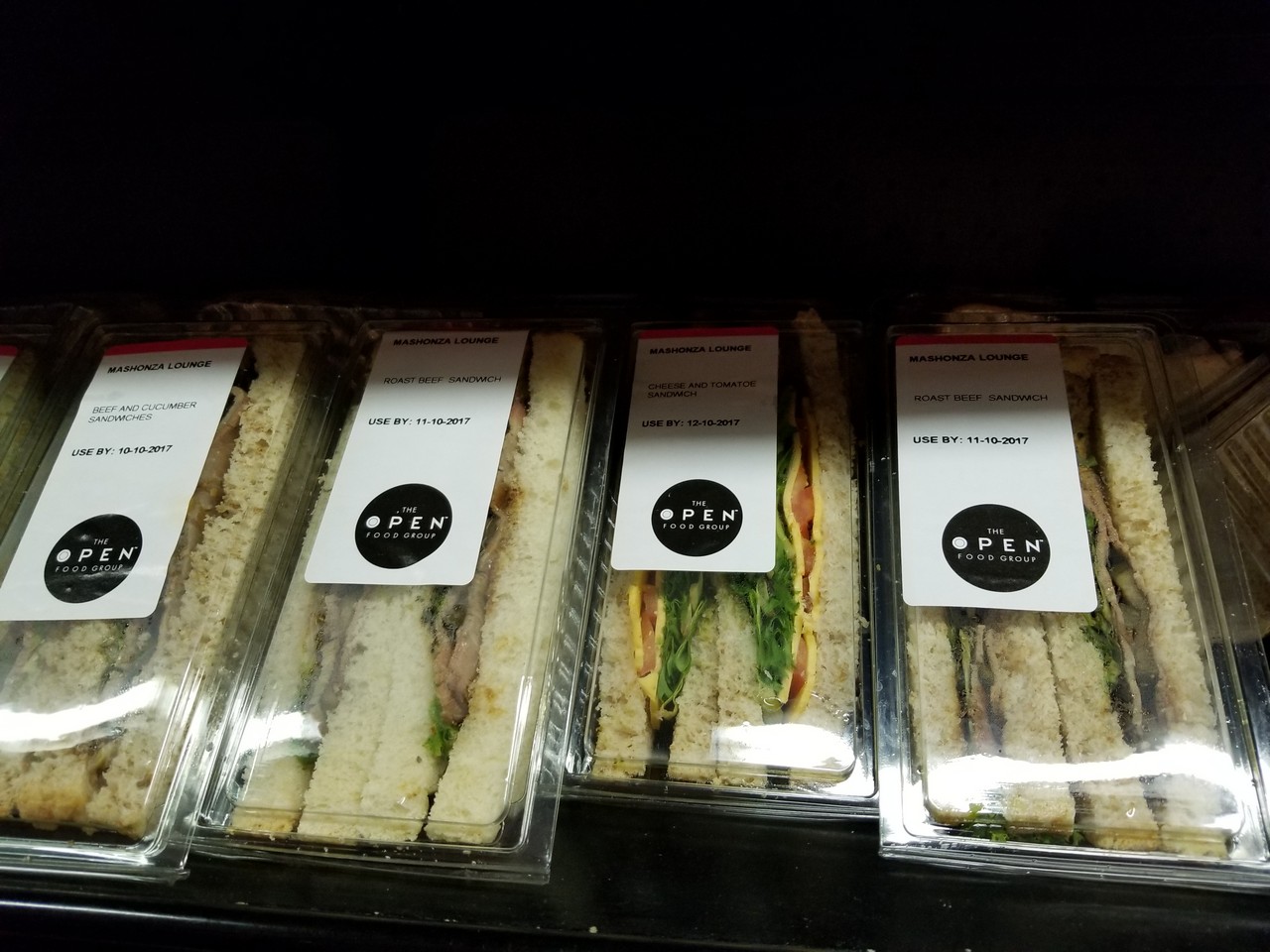 a group of sandwiches in plastic wrappers