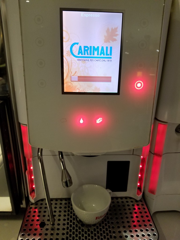 a machine with a screen and a cup