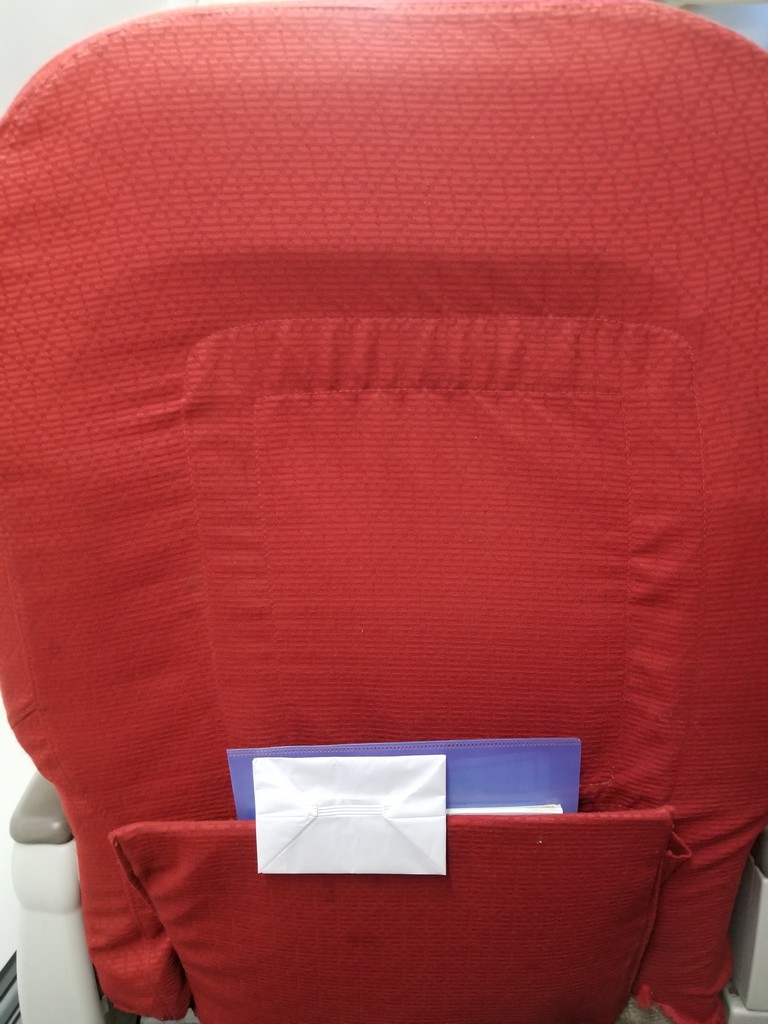 a red chair with a pocket