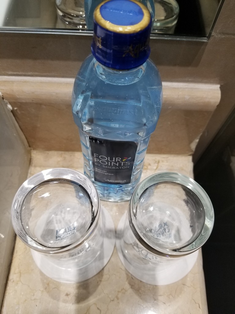 a bottle of water and two glasses