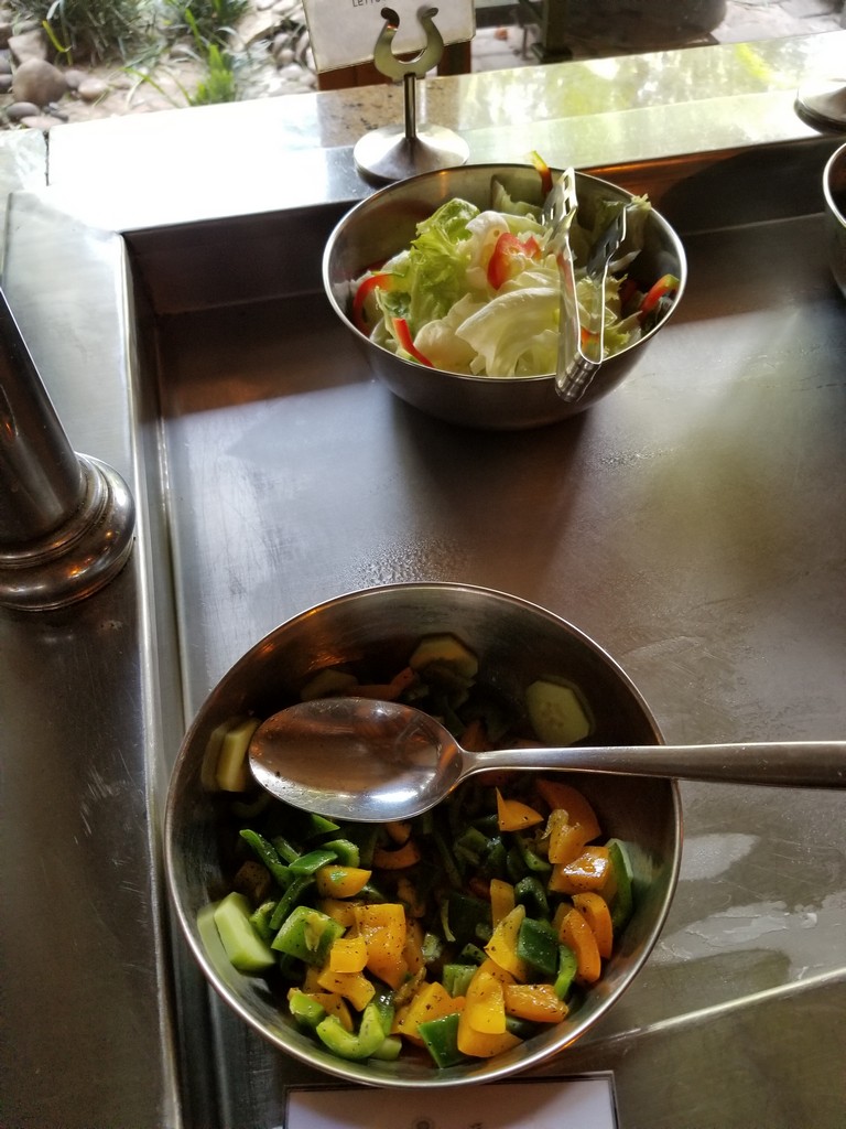 a bowl of salad and a spoon
