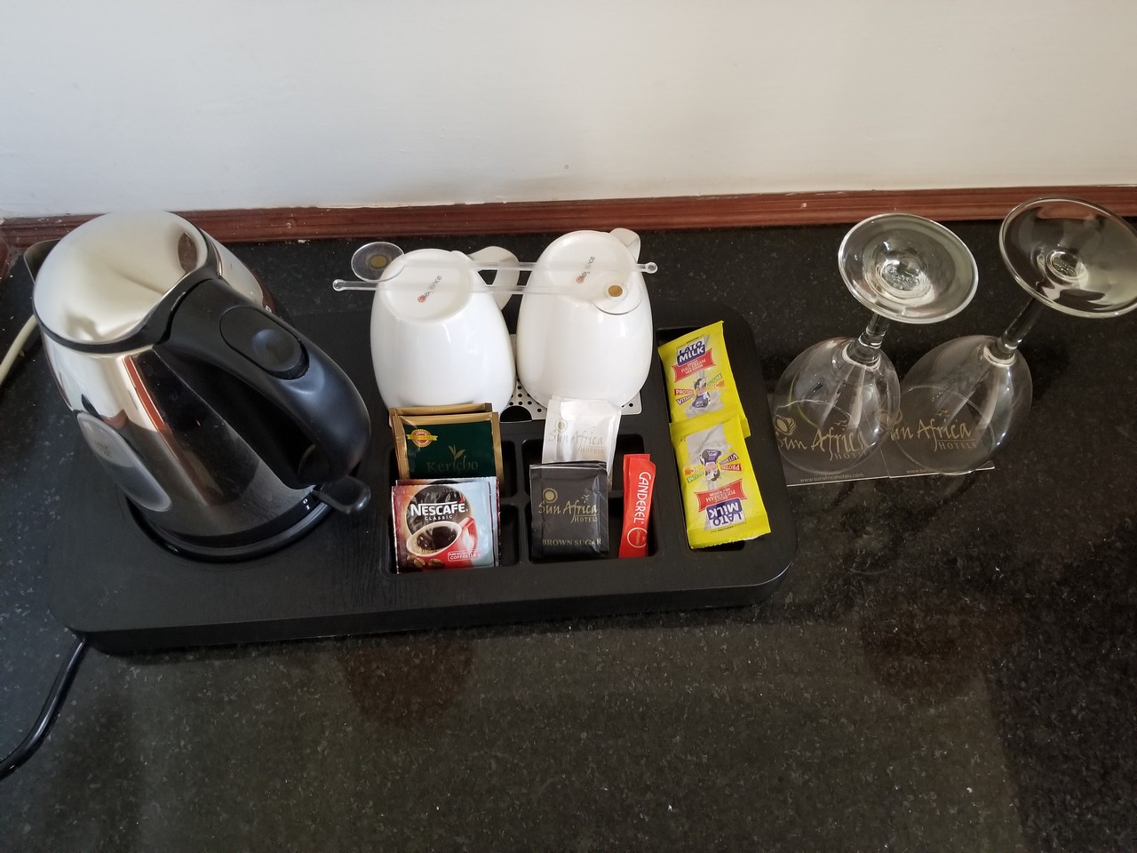 a coffee pot and condiments on a tray