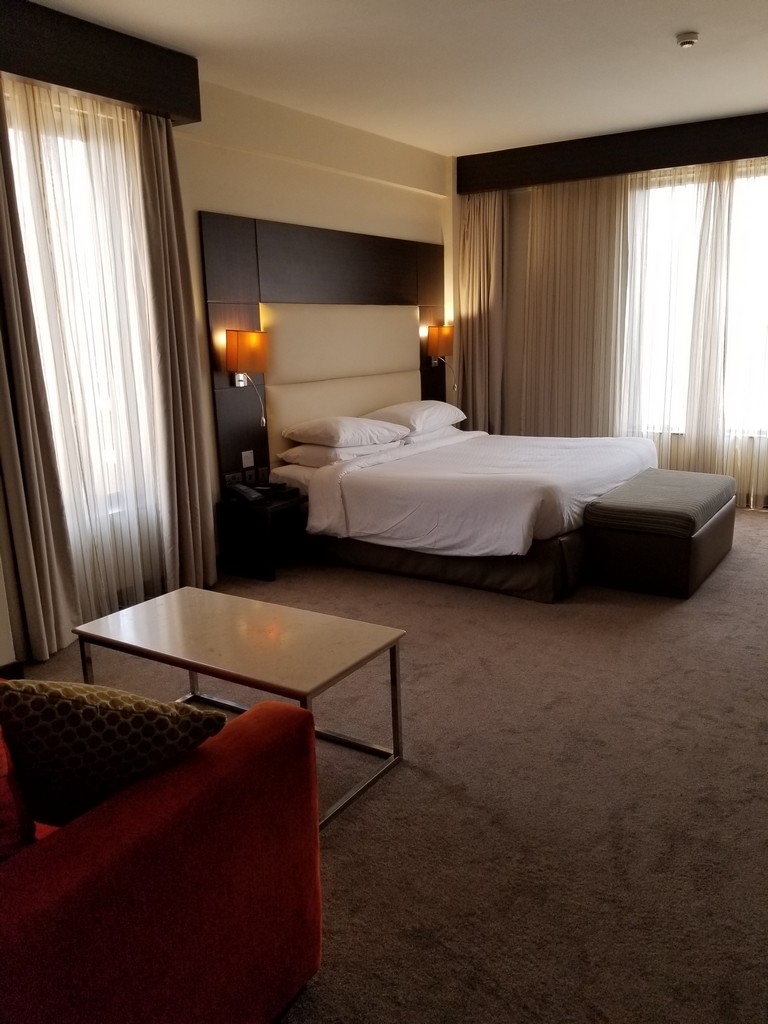 a hotel room with a bed and a table