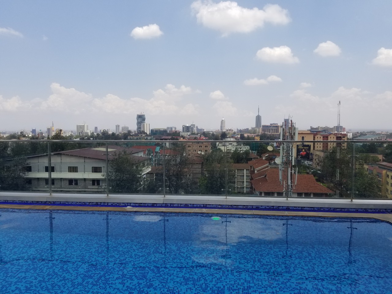 a pool with a city in the background