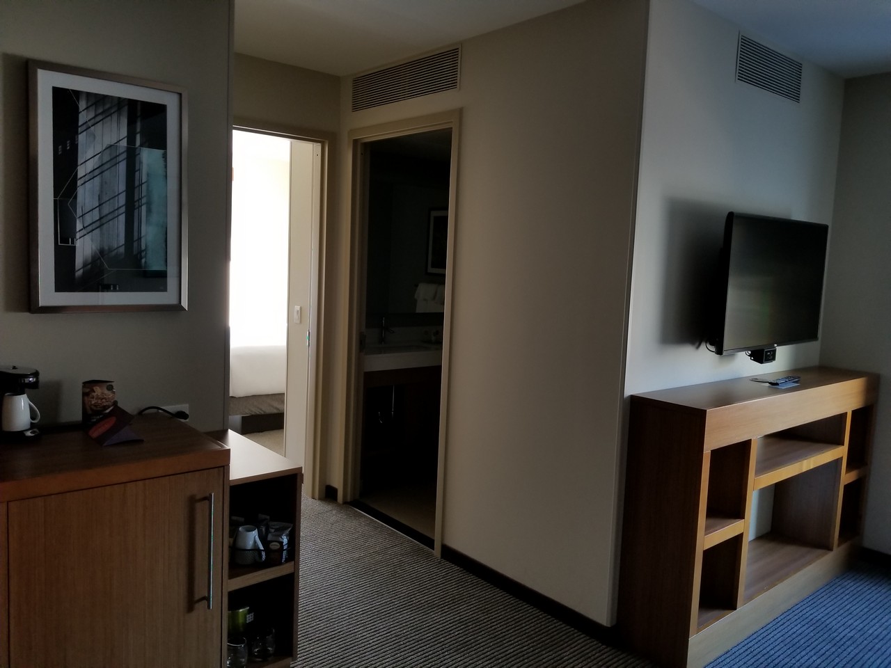 a room with a tv and shelves