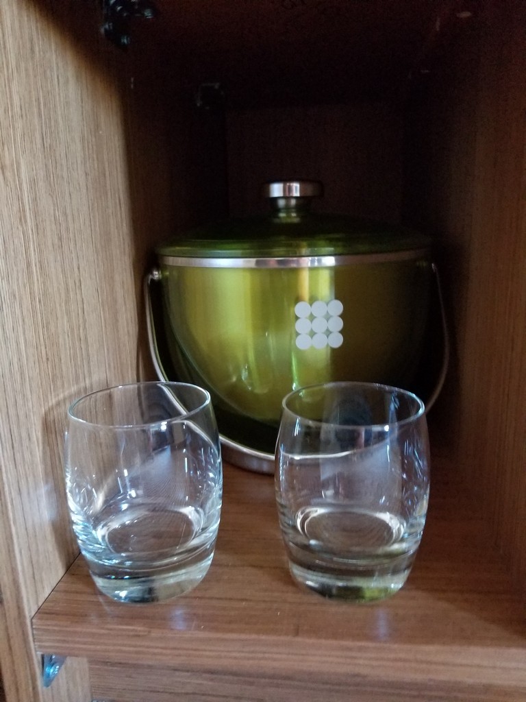 two glasses on a shelf