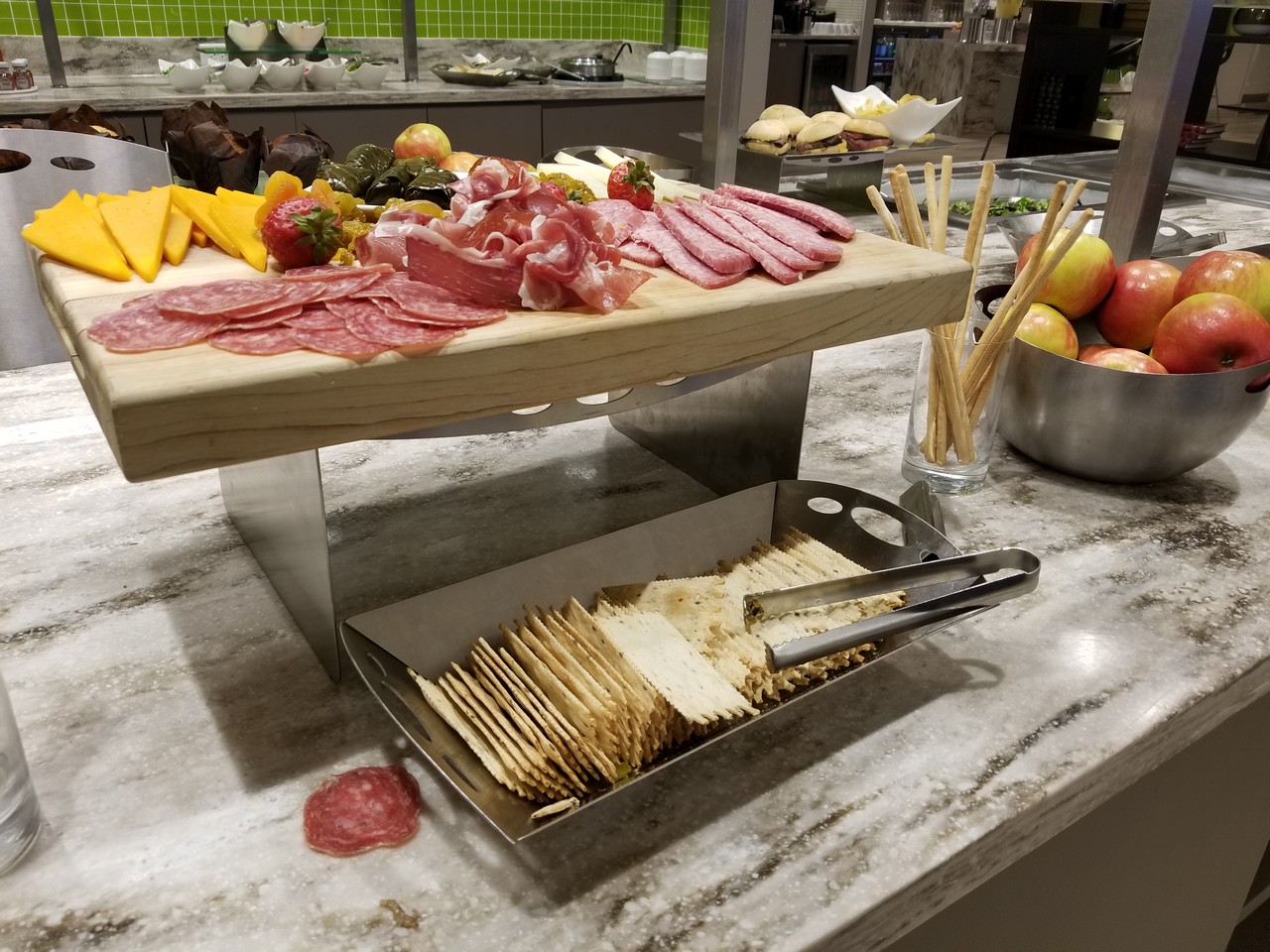 a tray of crackers and meat on a table