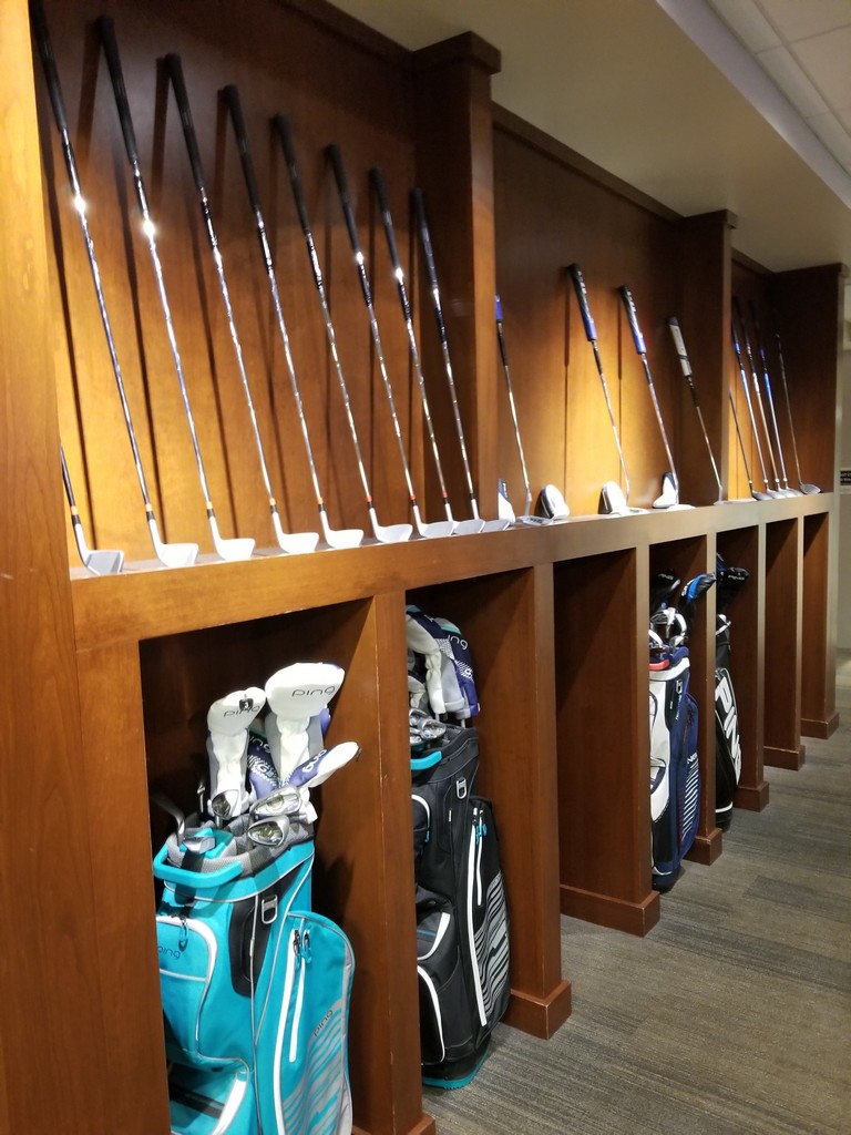 a row of golf clubs in a room