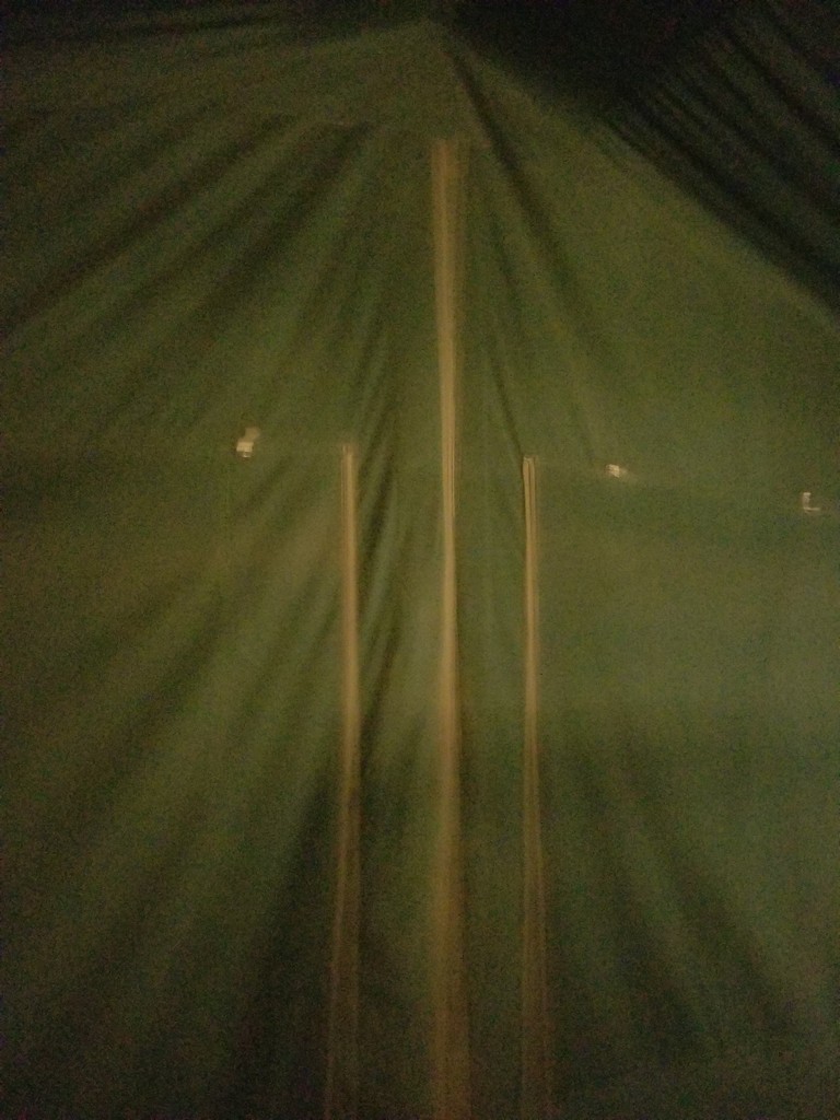 a green tent with a light coming out of it