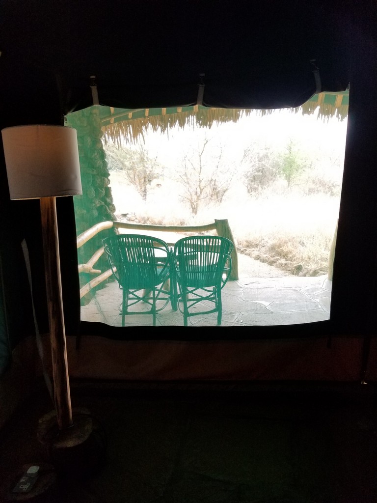 a table and chairs outside a window