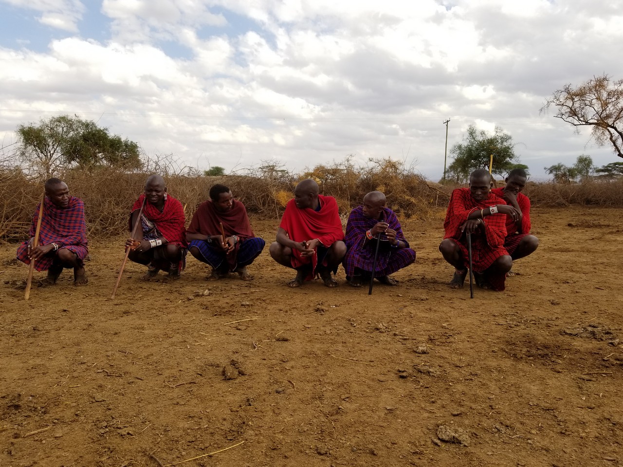a group of men kneeling in the dirt