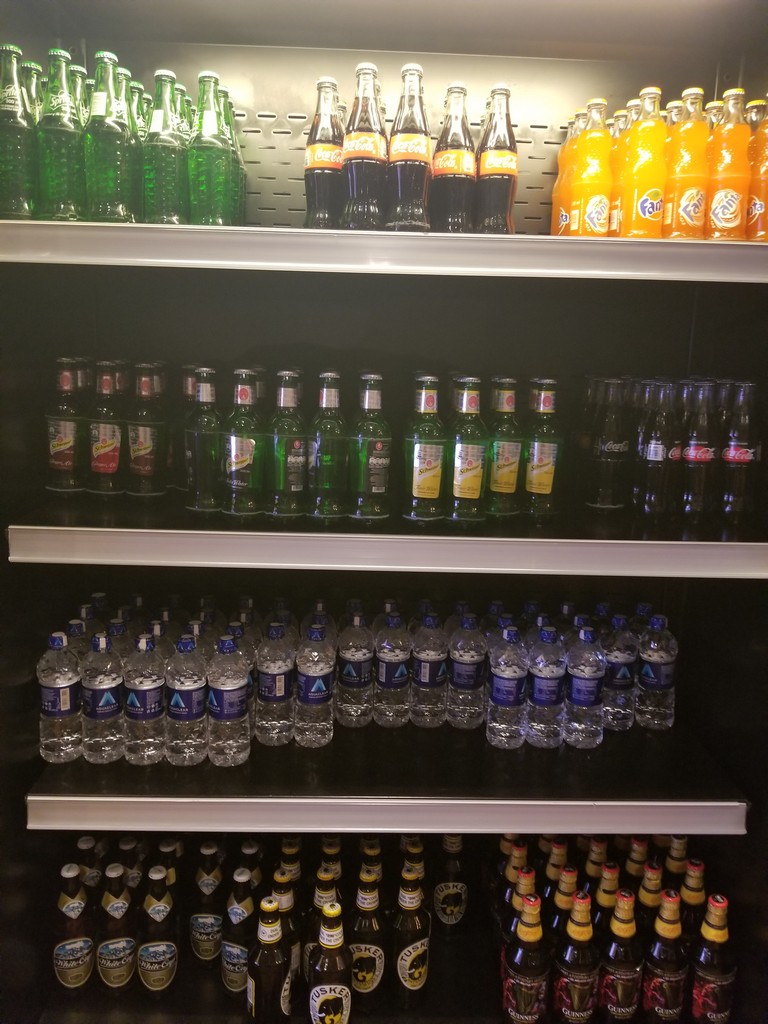 shelves with bottles of soda and bottles of water