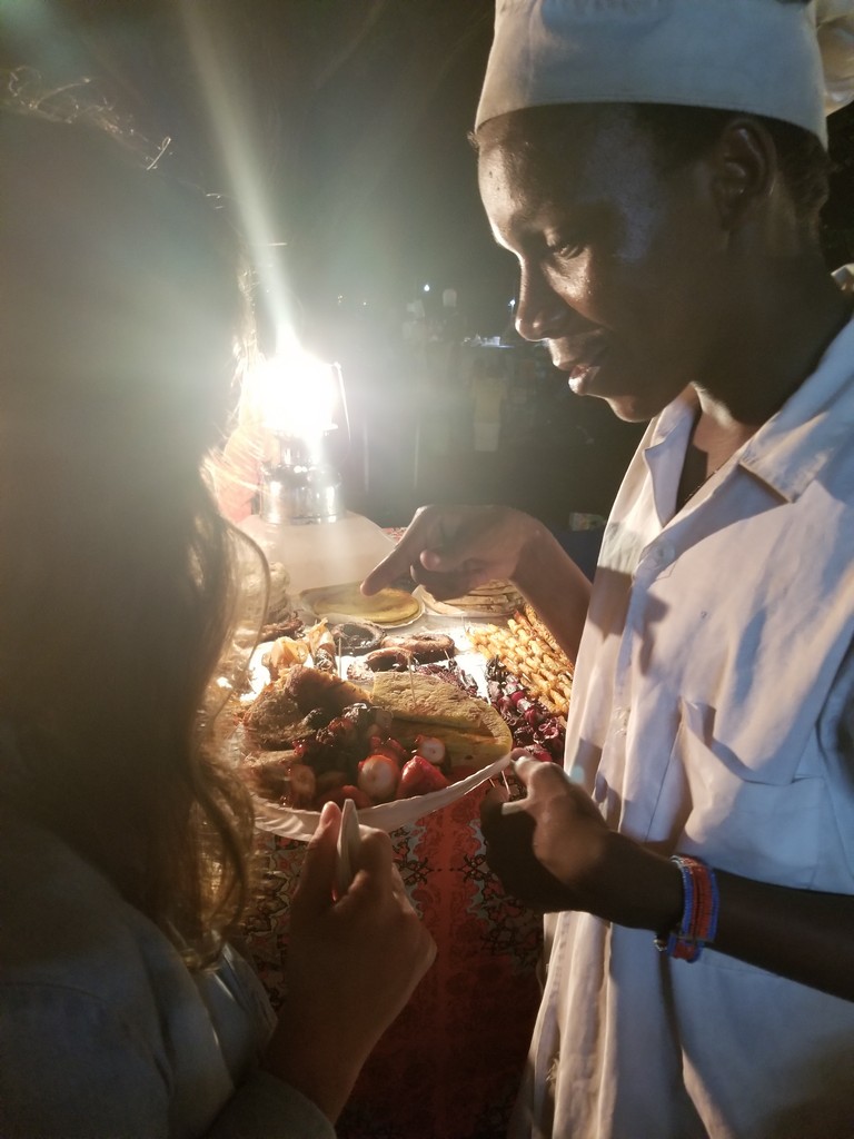 a man serving food to a woman