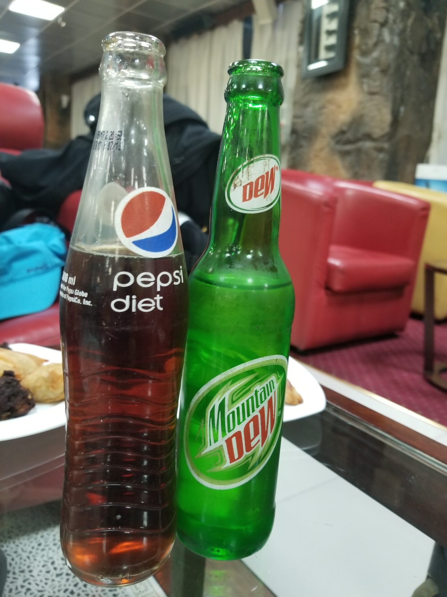 a glass bottles of soda on a table