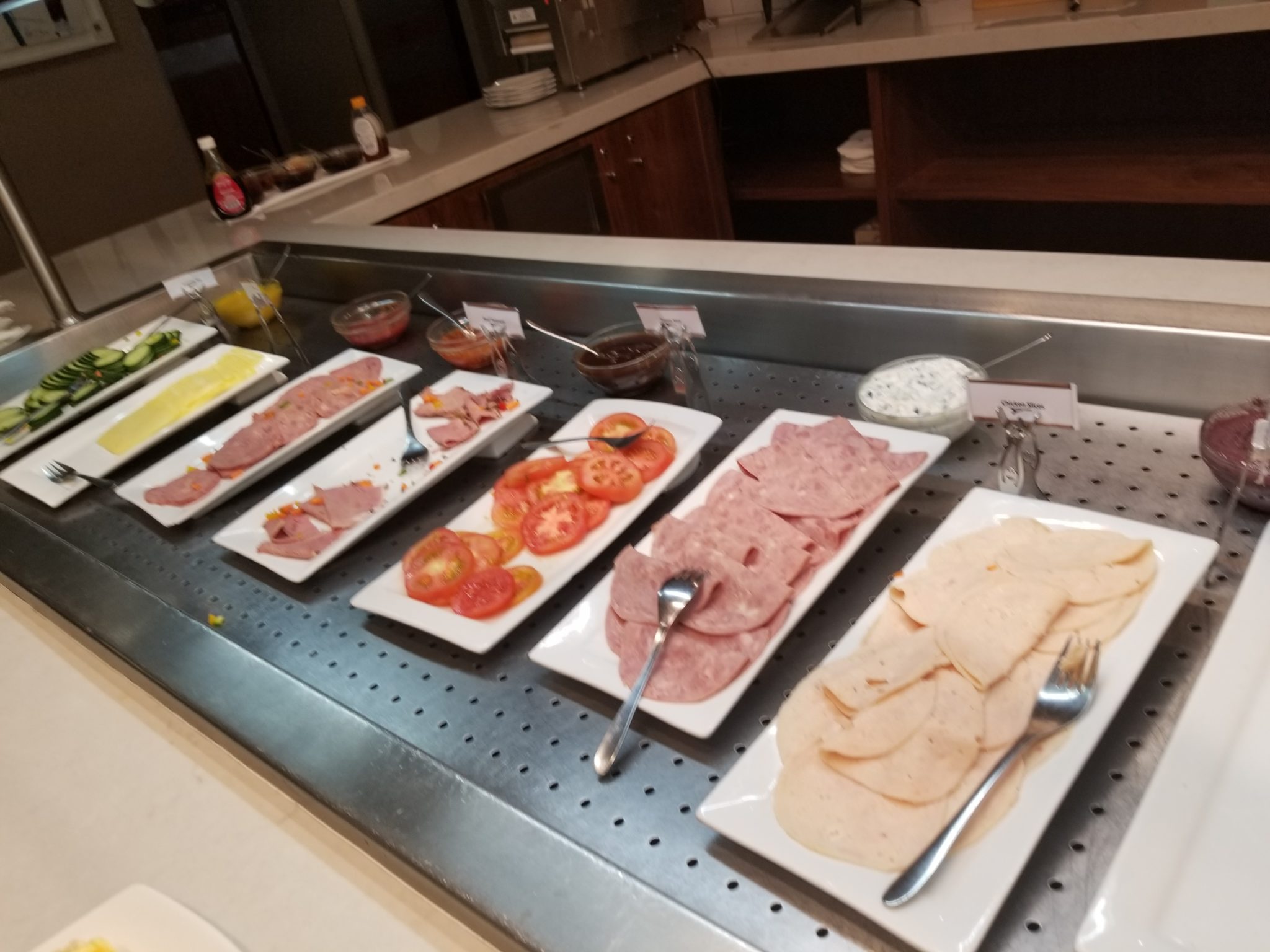 a buffet table with different types of food on plates