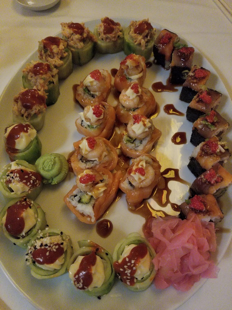 a plate of sushi on a white surface