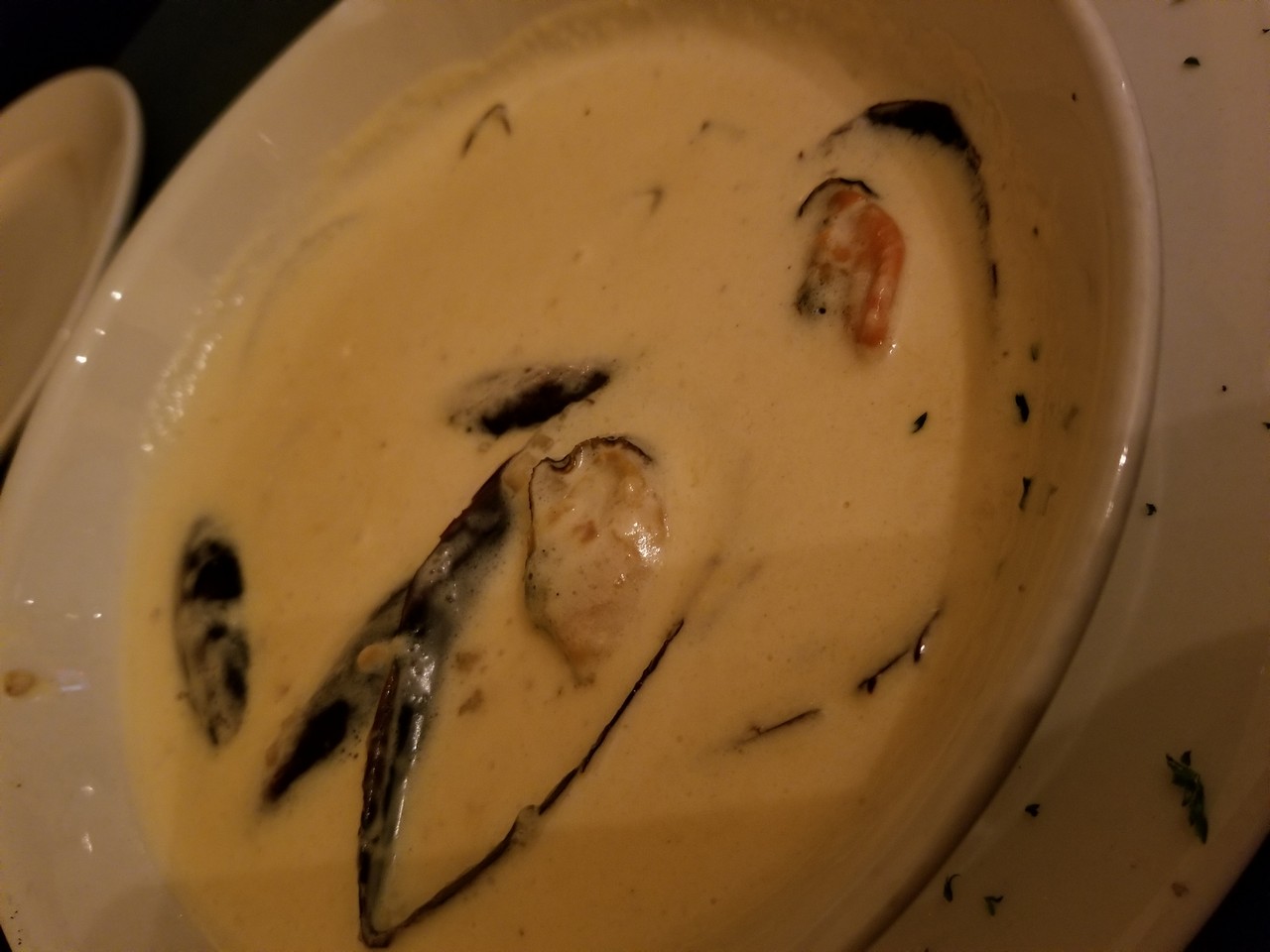 a bowl of soup with mussels