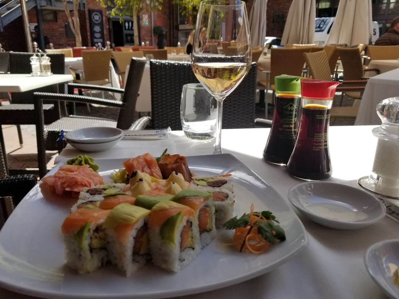 a plate of sushi and a glass of wine