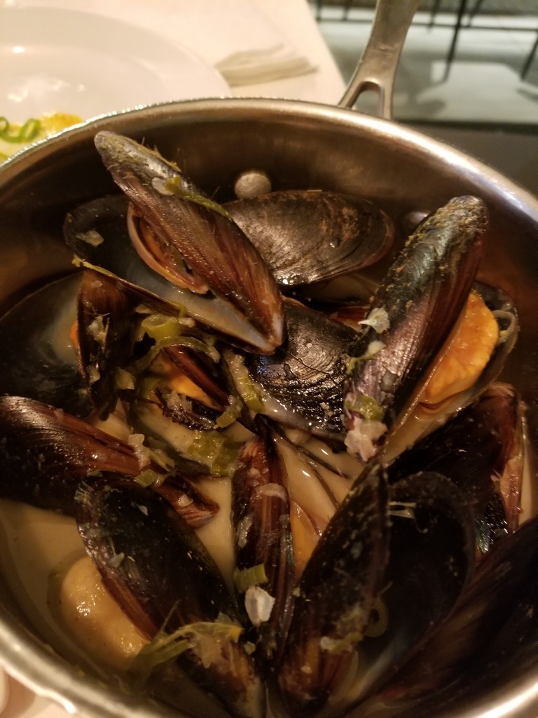 a bowl of mussels in a saucepan