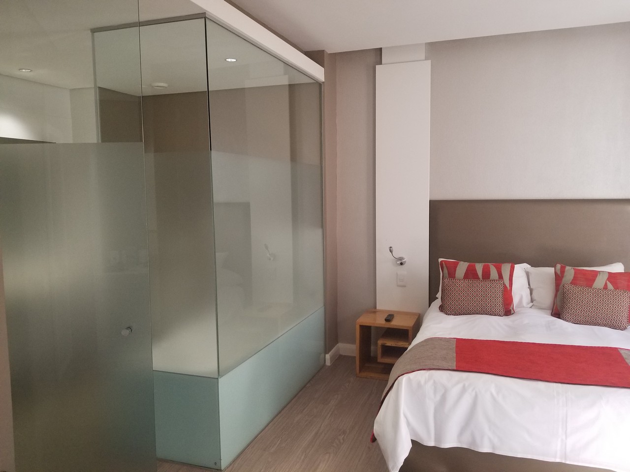 a bedroom with a glass shower