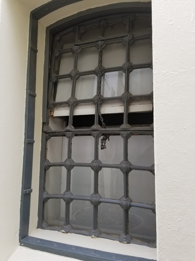 a window with a chain on the side