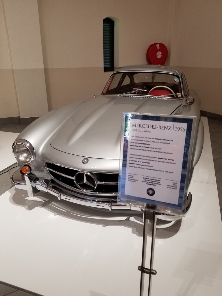a silver car on display