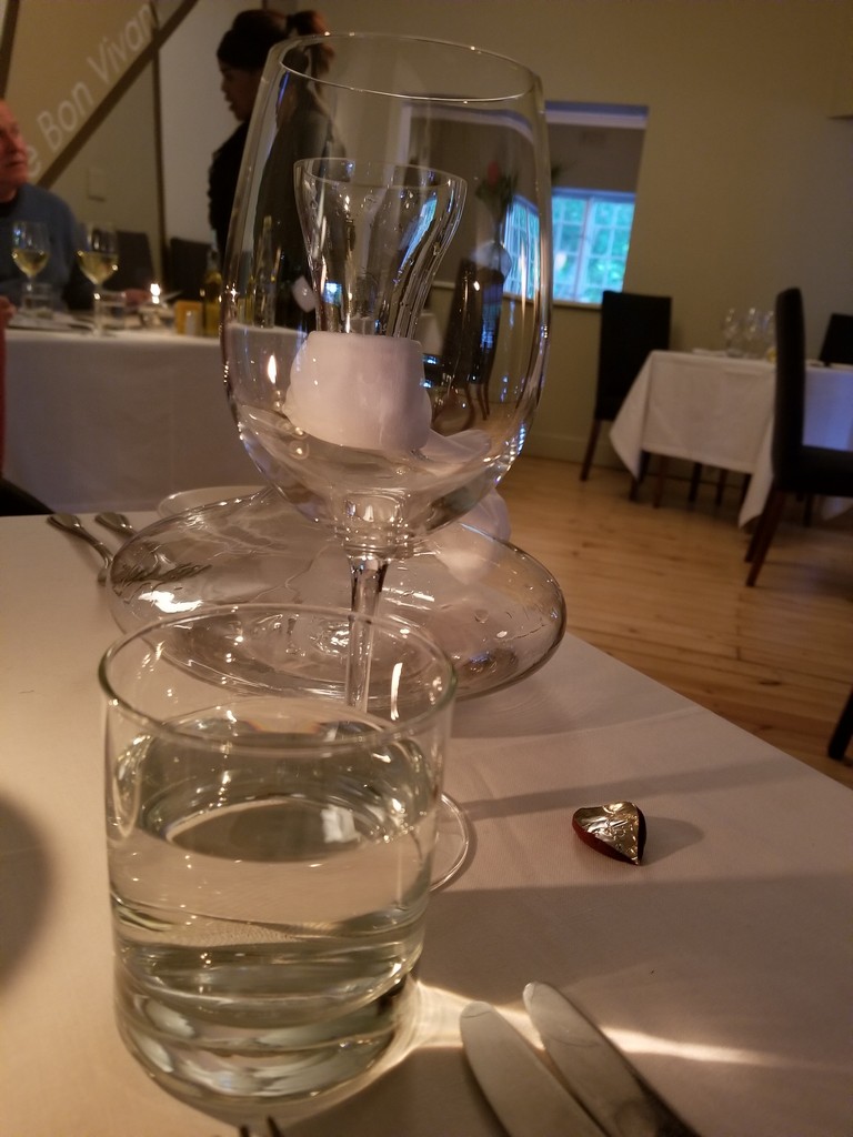 a glass and water on a table
