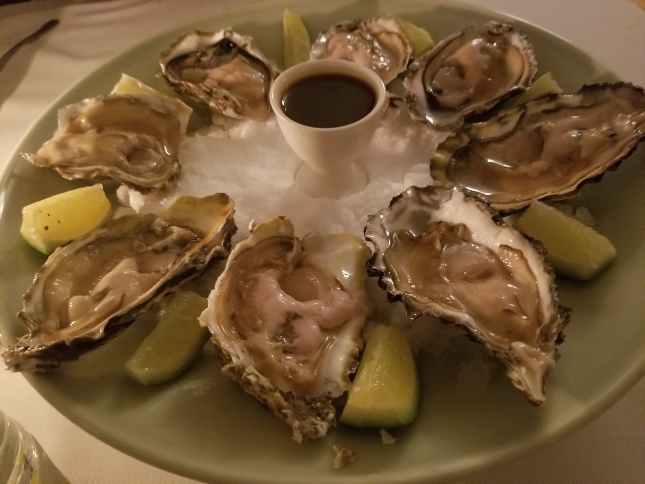 a plate of oysters and lemons