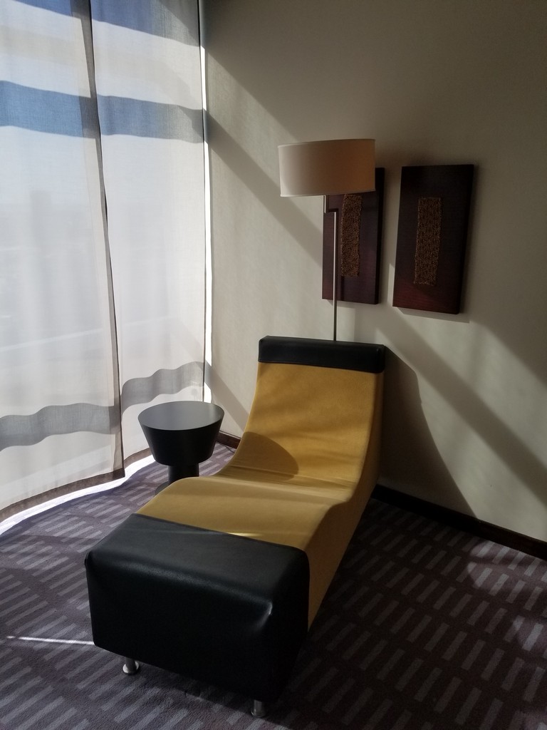 a chair with a lamp in a room