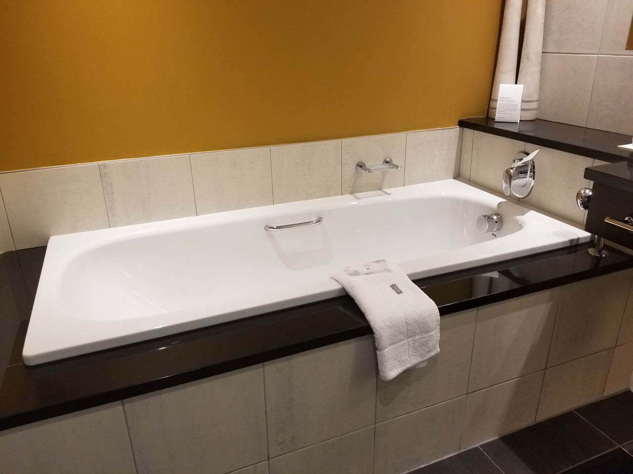 a bathtub with a towel on the edge
