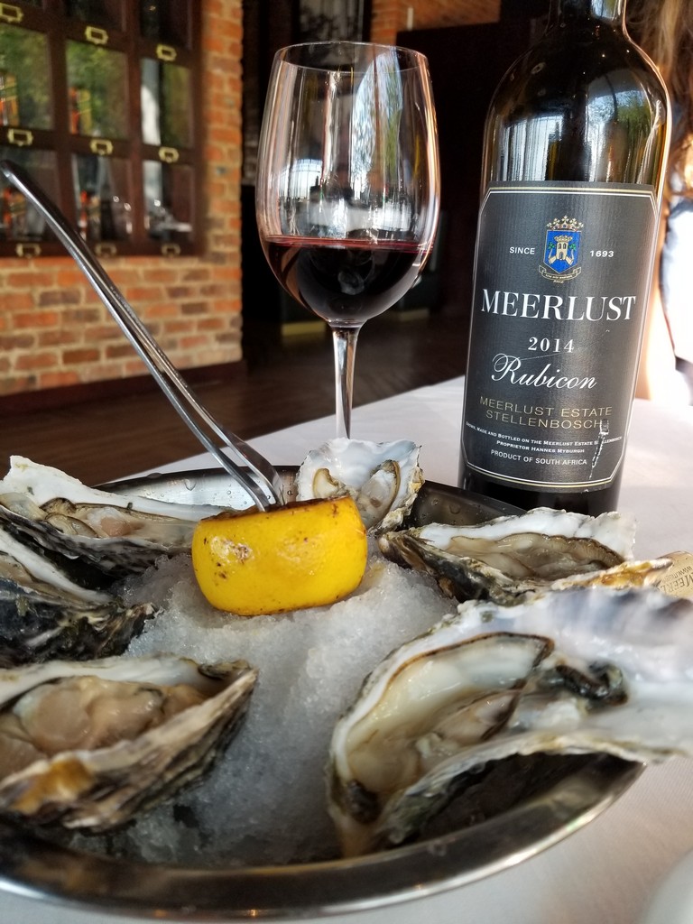 a plate of oysters and a glass of wine