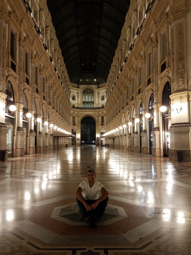 a man sitting on the floor in a large building