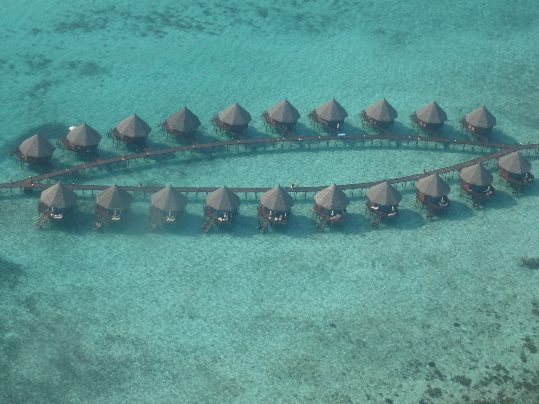a group of huts on stilts in the water