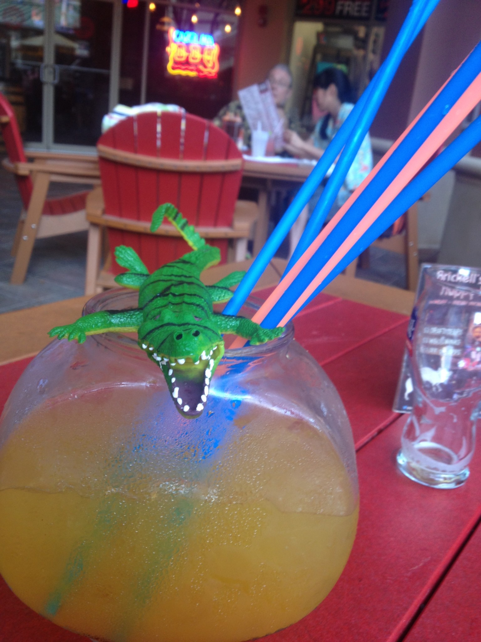 a toy lizard in a glass of liquid